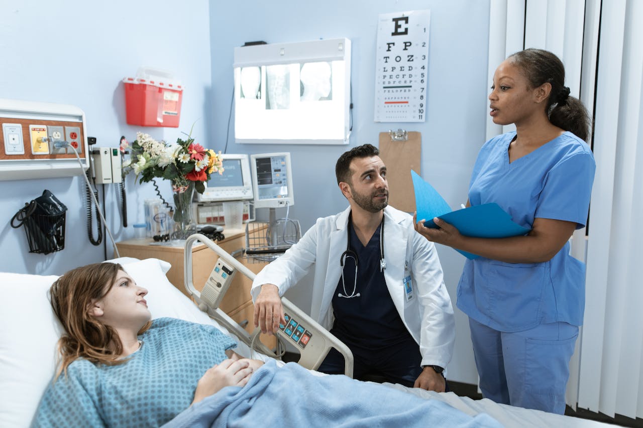 Doctor and nurse bedside with patient